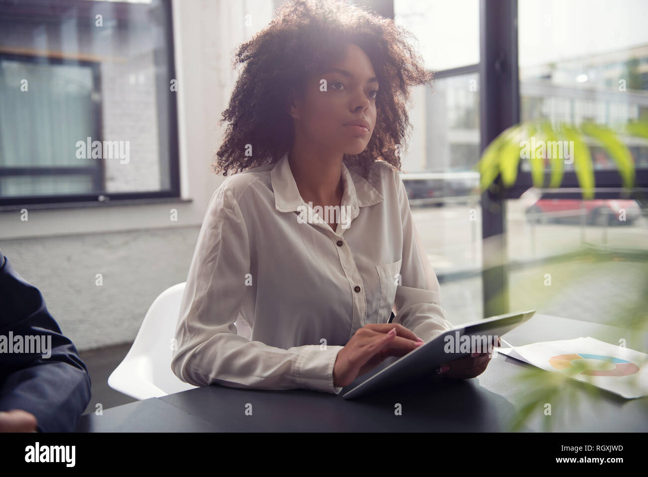 Businesswoman works in office with a tablet. Concept of internet sharing and company startup Stock Photo