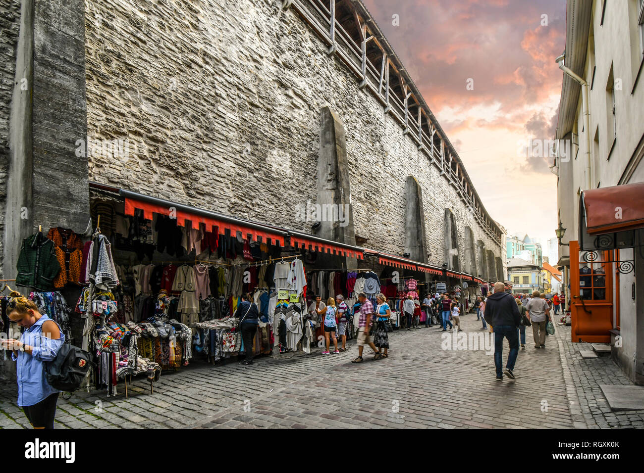 Tallinn, Estonia - September 10 2018: Tourists shop an outdoor marketplace under the medieval city walls of Tallinn, Estonia Stock Photo