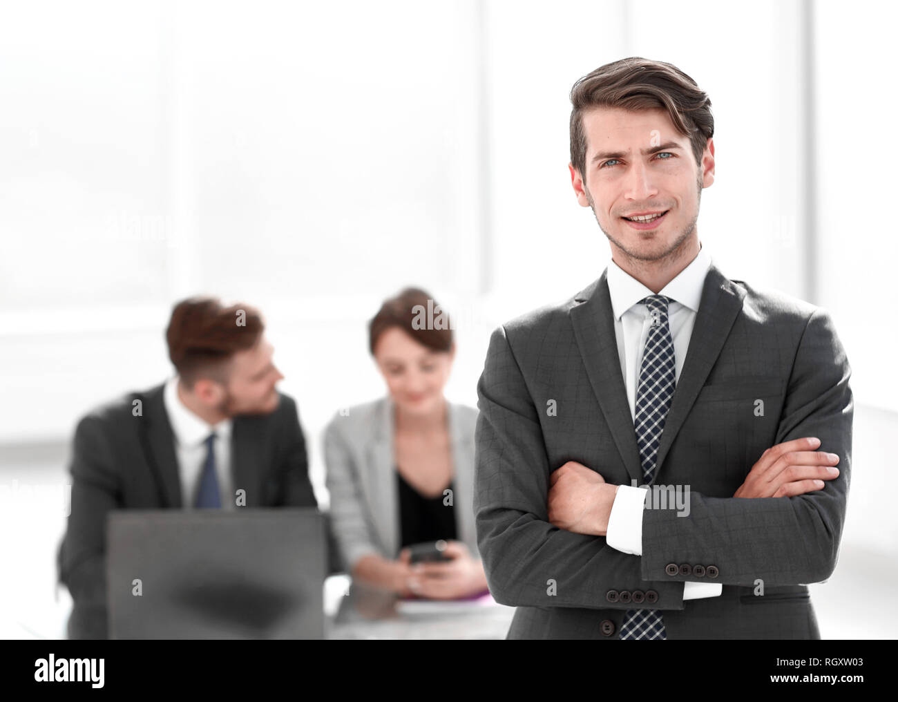 young businessman standing in the office Stock Photo - Alamy