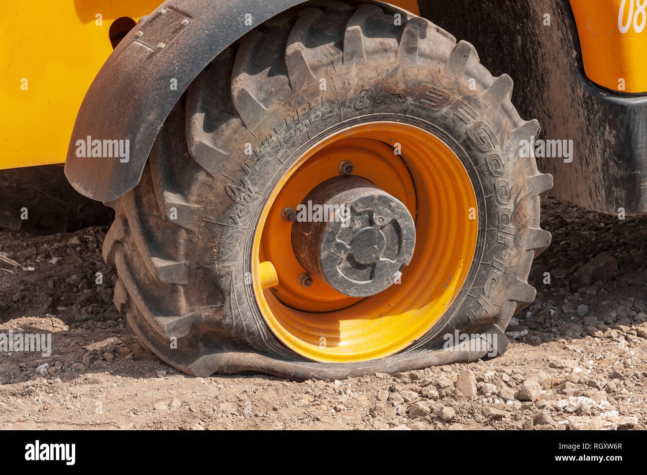 Close up on a tire deflated from a public works machine. Stock Photo