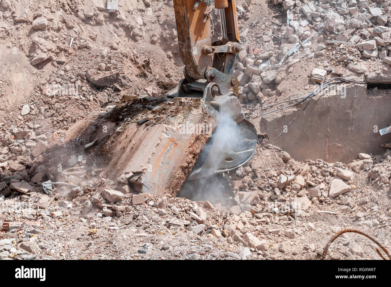 On A Demolition Site The Bucket Of An Excavator Pulls A Concrete Slab Remains Of Foundation Of A Building Stock Photo Alamy