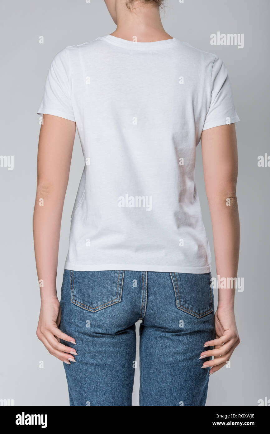 back view of woman posing in white t-shirt with copy space, isolated on grey Stock Photo