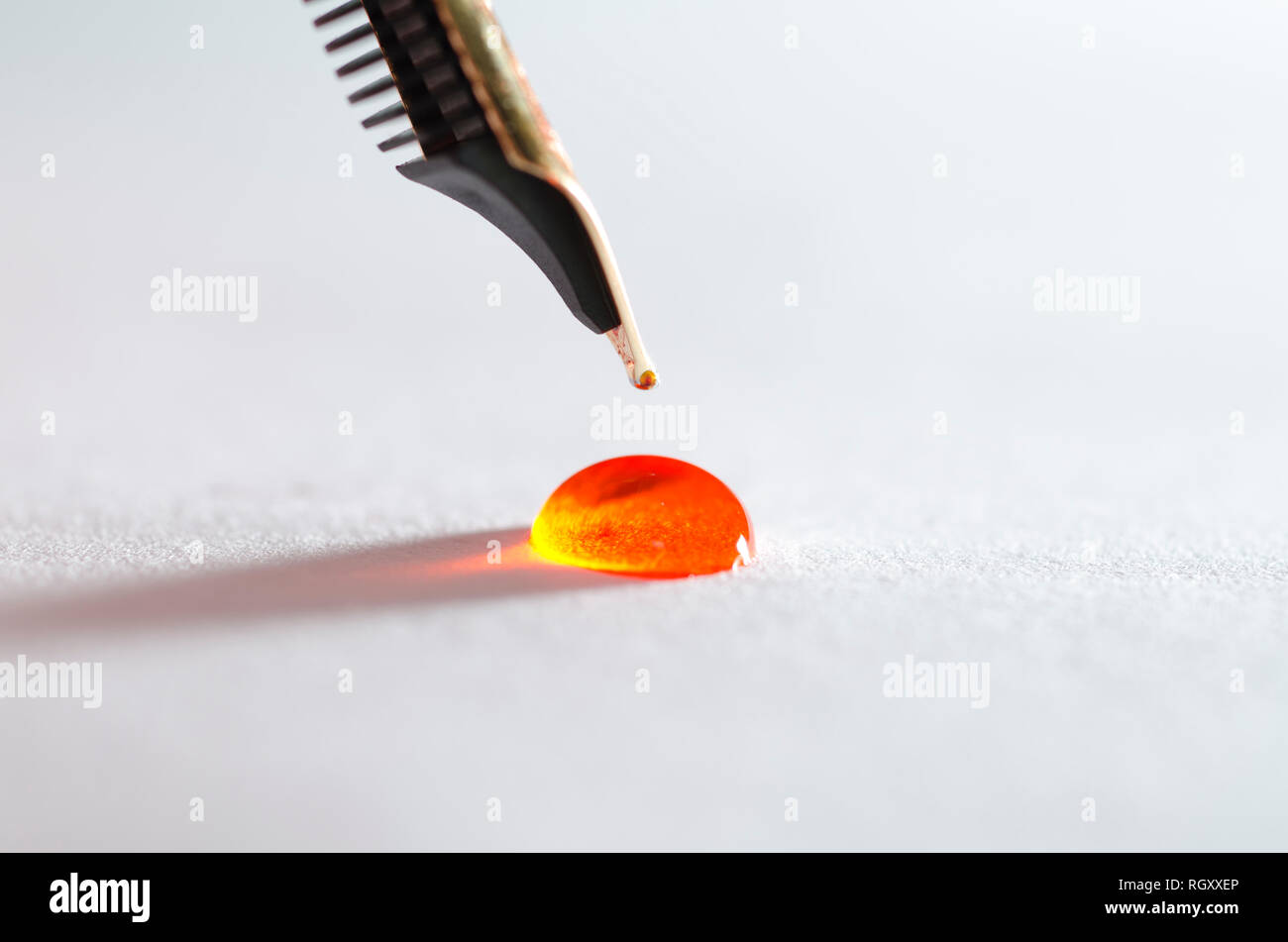 Stylograph Pen Tip with ink Drop on White Paper. Stock Photo