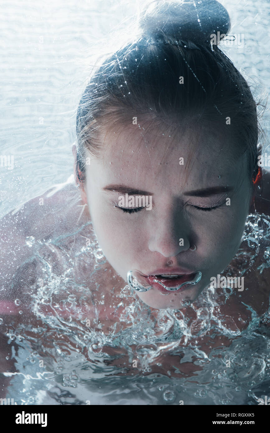 close up of young woman posing underwater with closed eyes Stock Photo