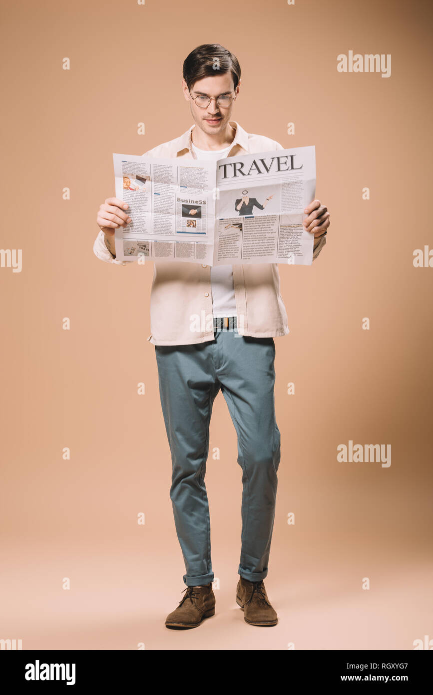 Handsome Man Reading Travel Newspaper On Beige Background Stock Photo Alamy