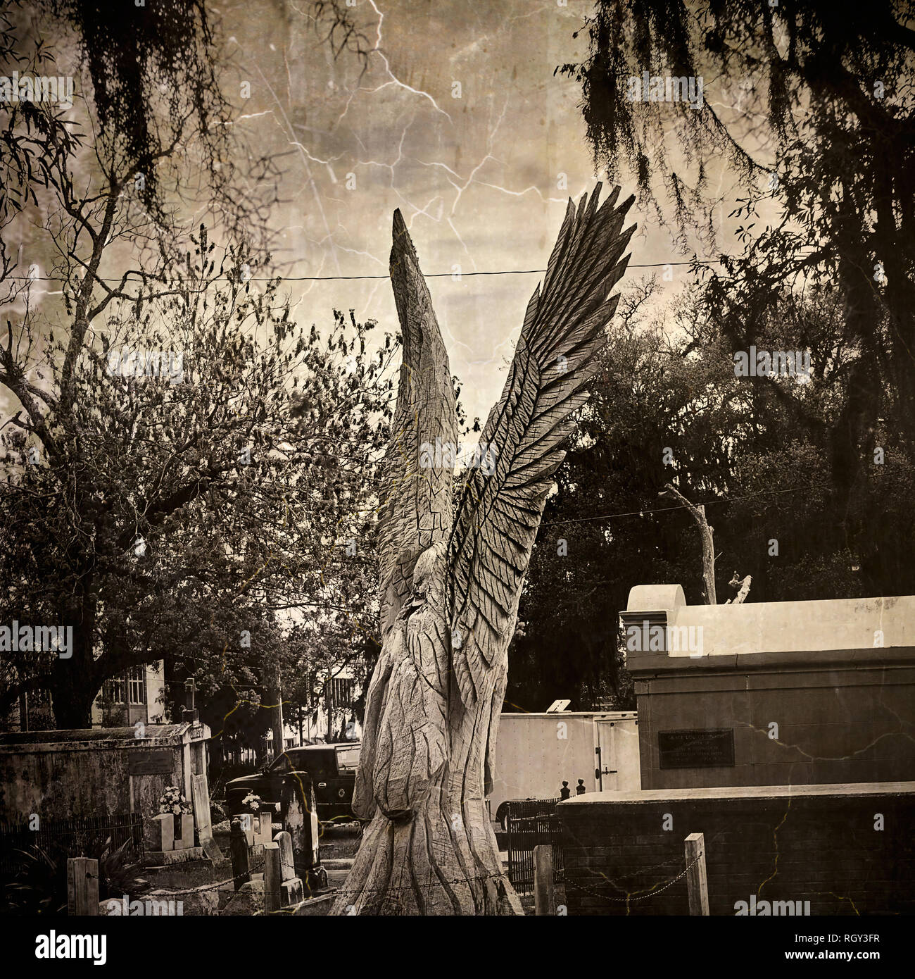 A wooden angel, carved from a tree damaged by Hurricane Katrina, is pictured at Cedar Rest Cemetery, April 6, 2018, in Bay Saint Louis, Mississippi. Stock Photo