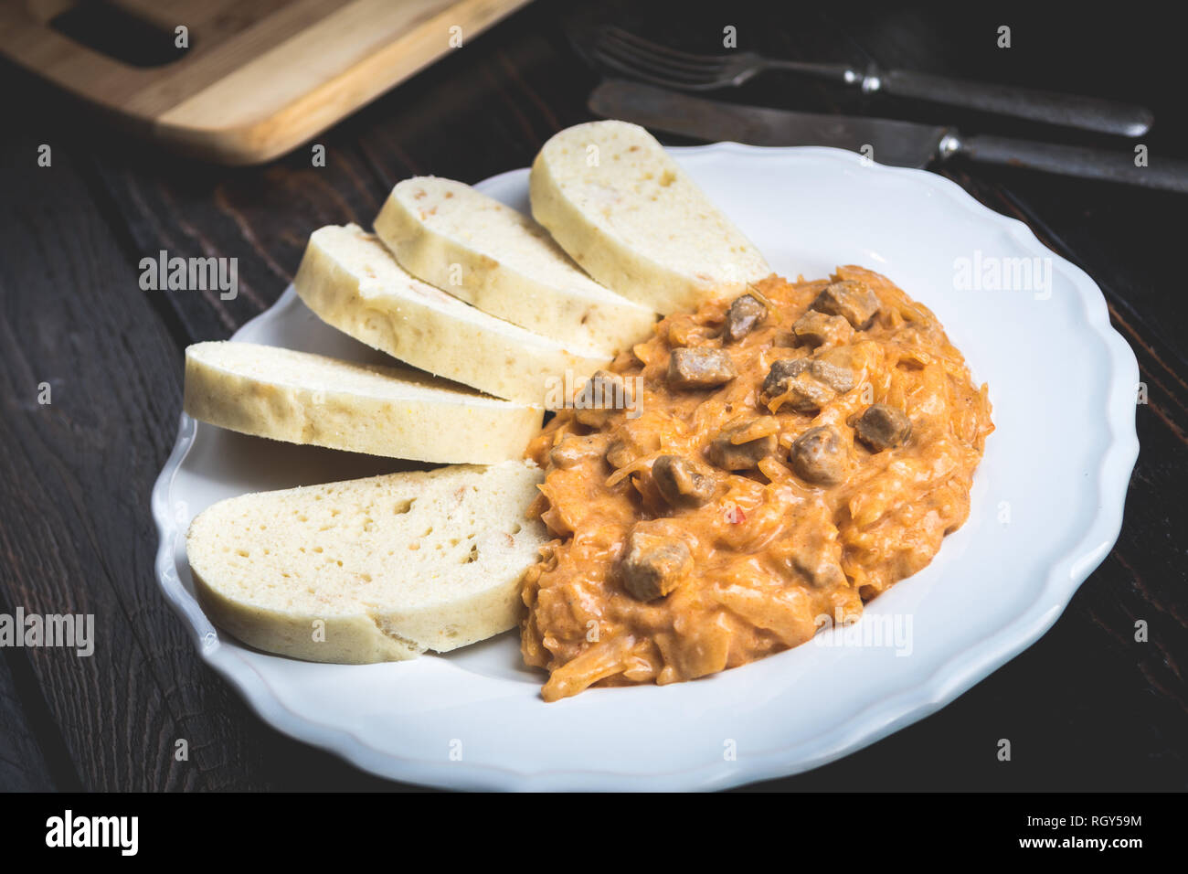 Traditional hungarian goulash (szeged gulyasz),  with pork and pickled white sauerkraut and dumplings on wood table Stock Photo