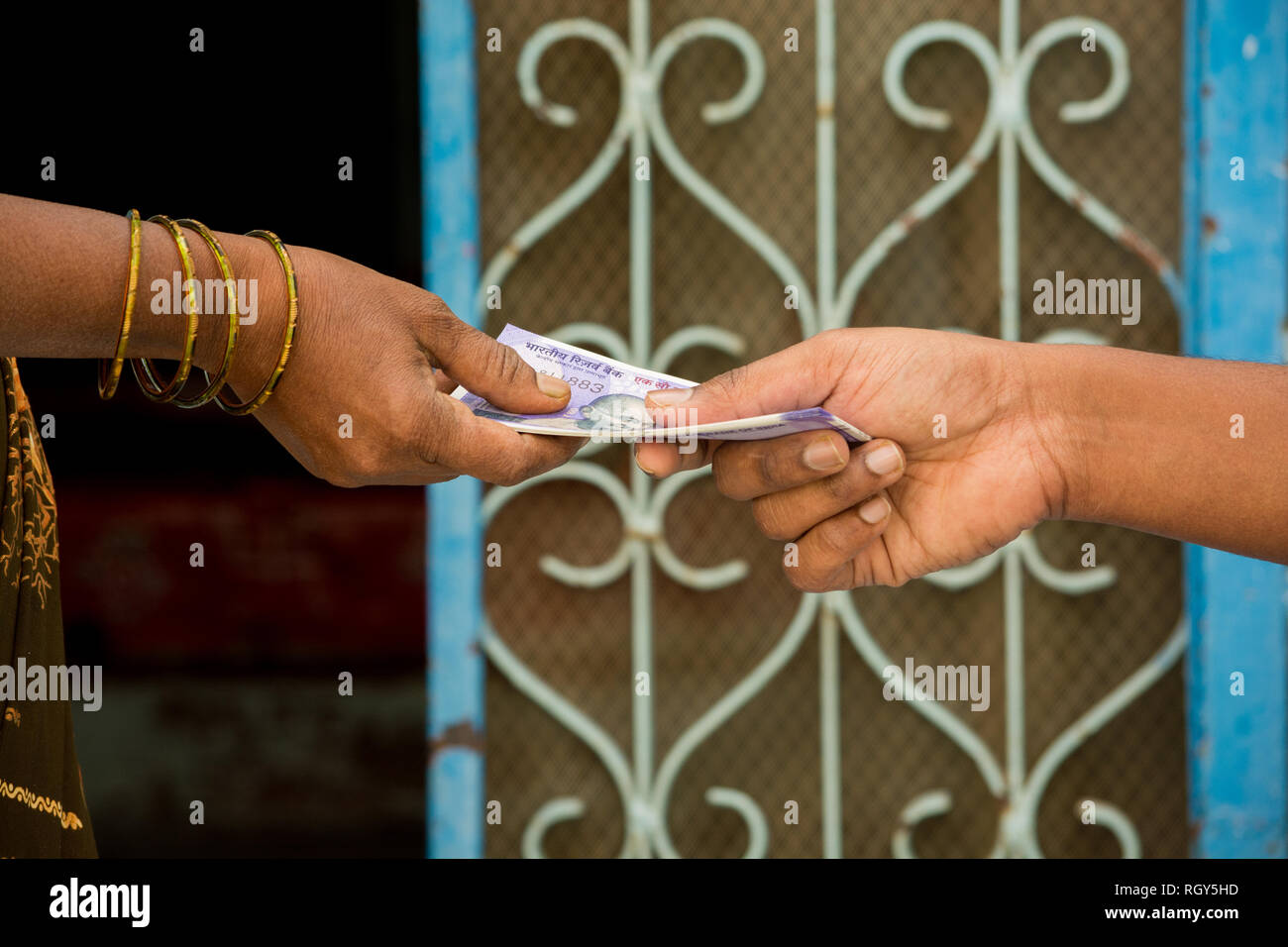 Close up of hands Indian women taking money in front of the house. Stock Photo