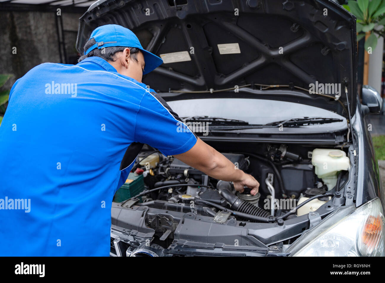 mechanic doing some inspection on car's engine Stock Photo - Alamy