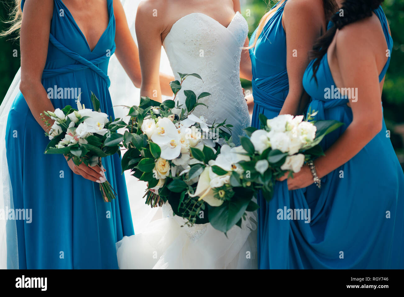 Wedding flowers in hand the bride and her bridesmaids. A feast for