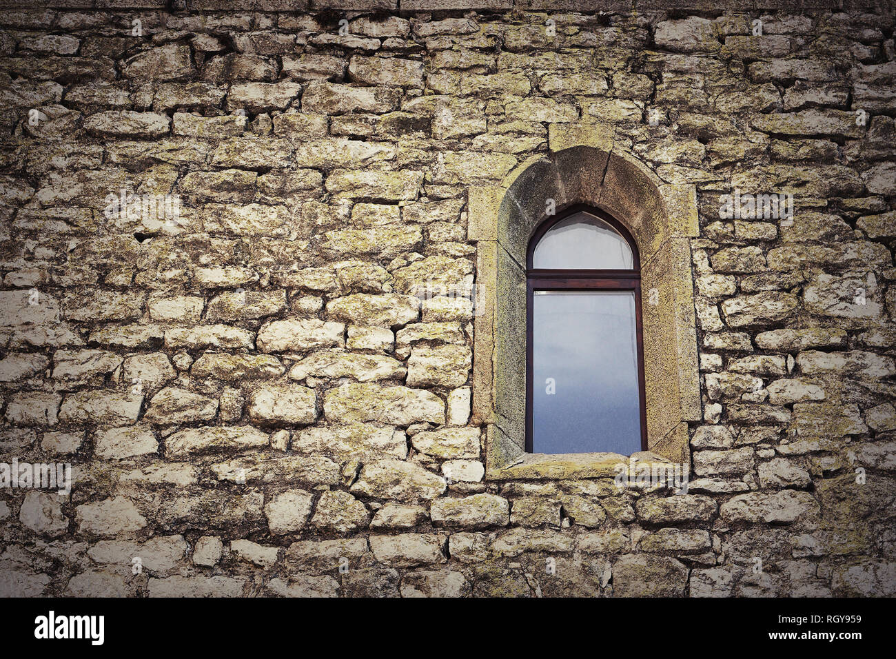 gothic window on old castle wall, textural image of historic building Stock Photo