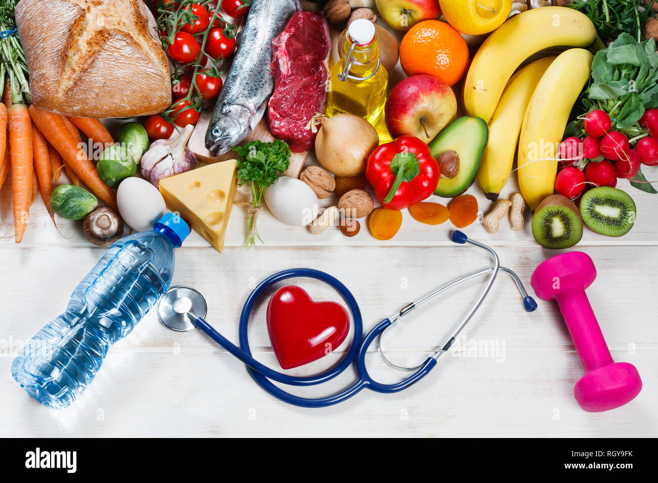 Healthy lifestyle and healthcare concept. Healthy food, heart and stethoscope Stock Photo