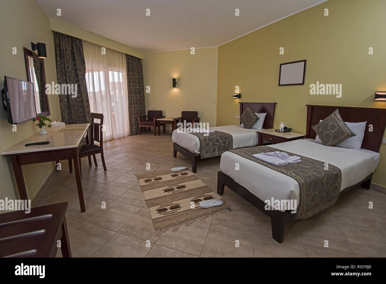 Twin Beds In A Luxury Hotel Resort Room With Curtains And Balcony