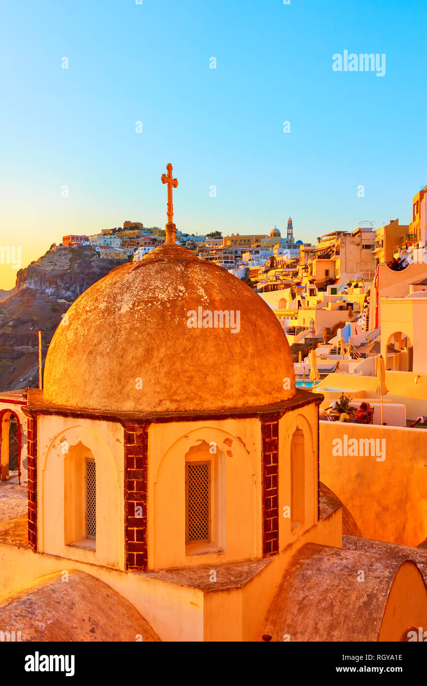 Old greek church and Thira town at sundown, Santorini Island, Greece. Space for text Stock Photo