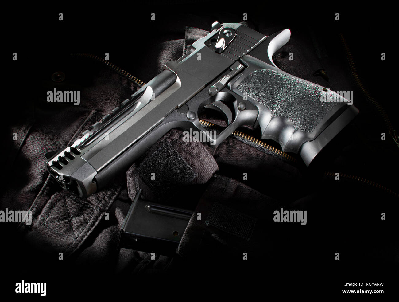 Black semi automatic handgun on a black nylon bag Stock Photo