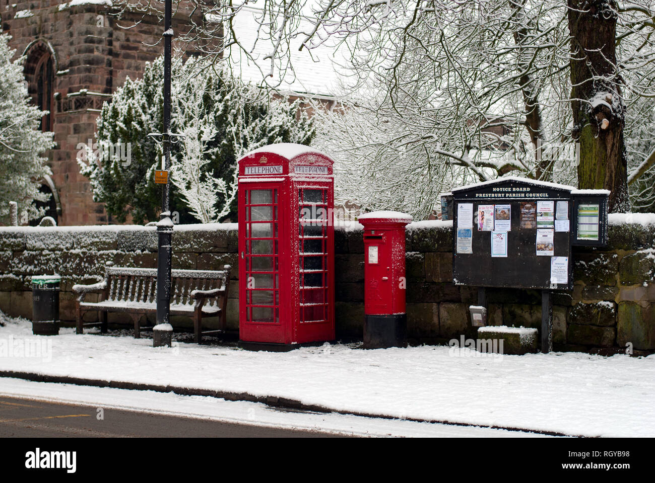 Old Phone box and snow in Prestbury Village Stock Photo