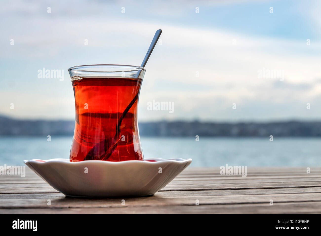 Turkish tea served in the typical manner, in a glass on a small saucer Stock Photo