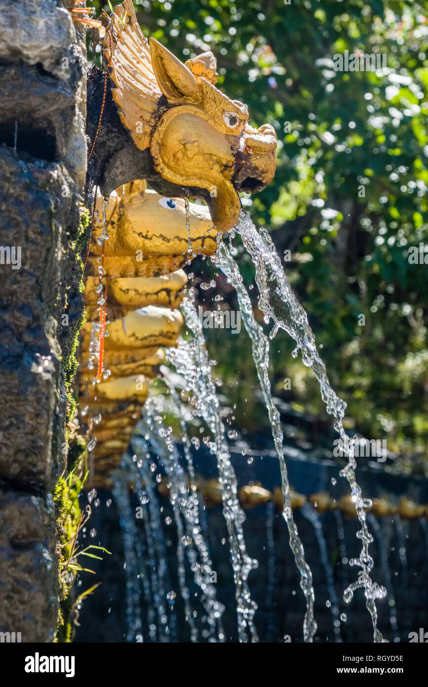 108 wells, decorated with a golden cow mouth, spending ice cold holy water in Muktinath Temple, one of the Vaishnava Divya Desam Stock Photo