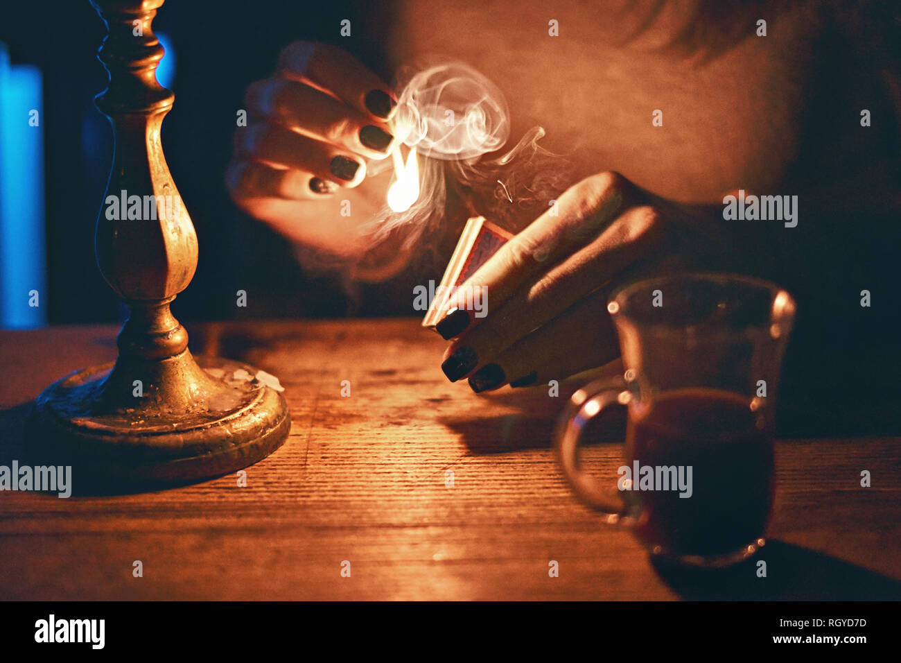 Young beautiful fortune teller woman in a mysterious setting with