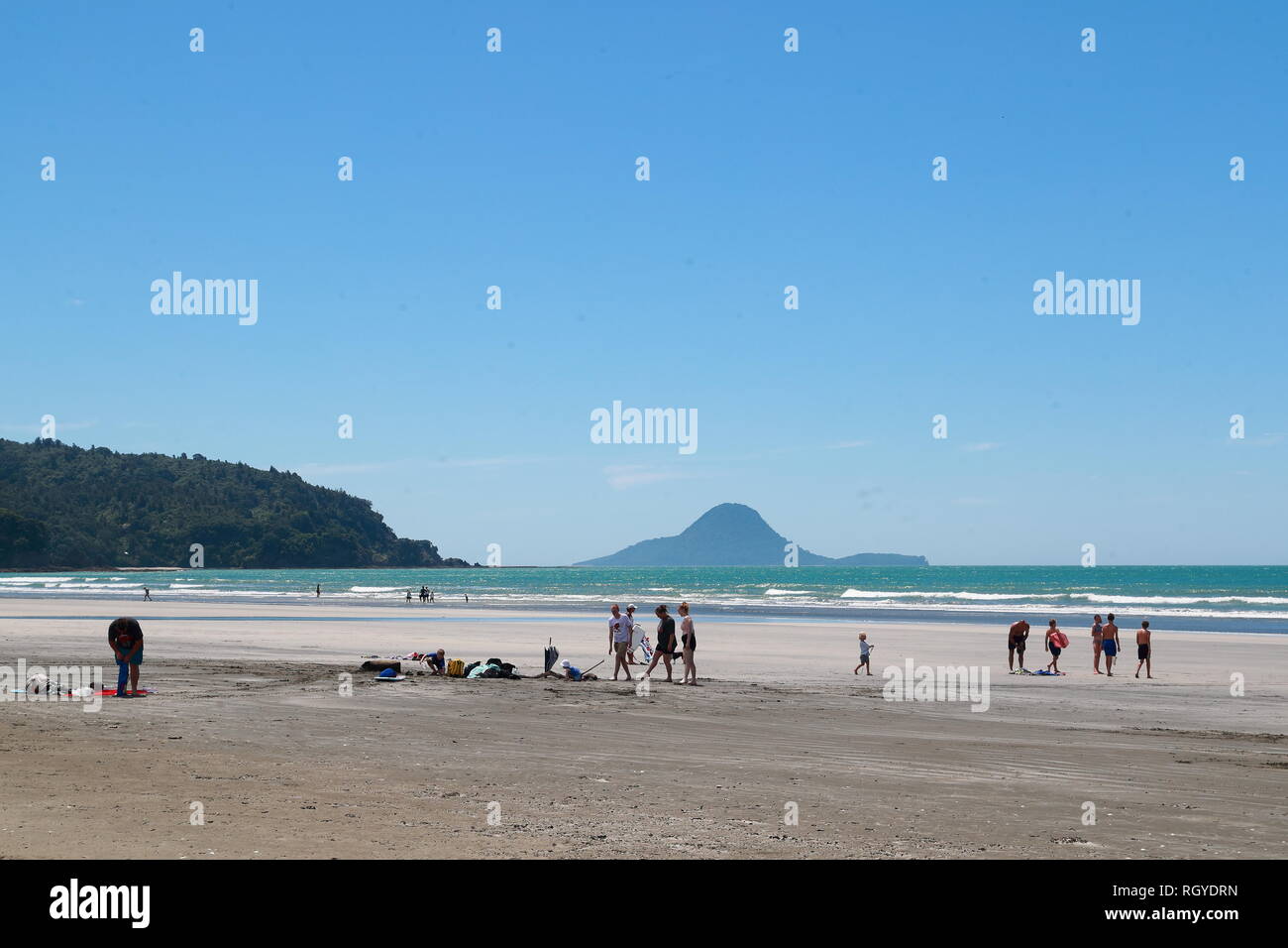 Swimmers and water sport fans enjoy themselves at Whakatane beach, New Zealand Stock Photo