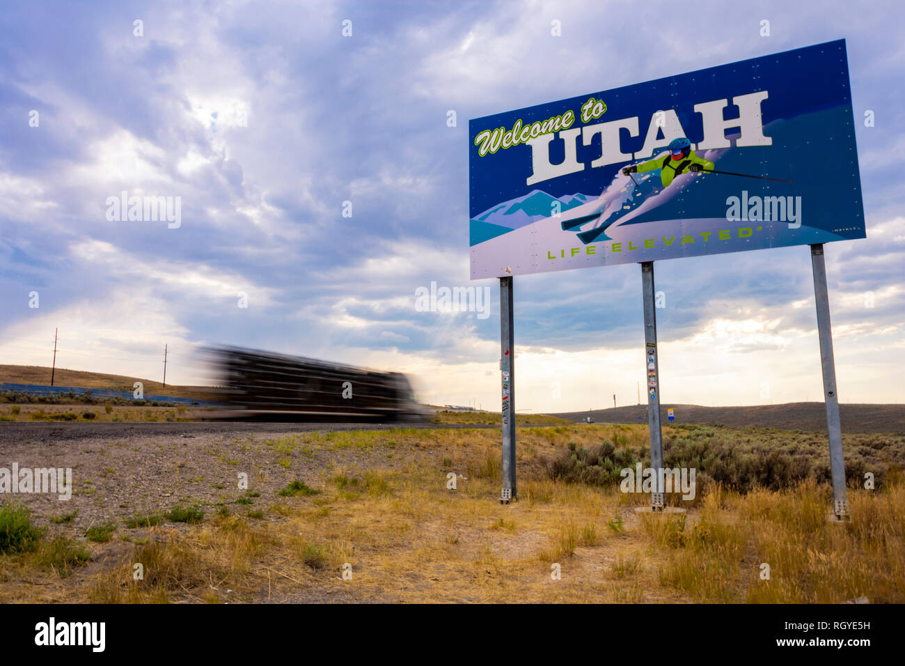 Evanston, Utah, United States - August 15, 2018: Shot of a truck driving by the Welcome to Utah sign located on the interstate highway I-80 in Evansto Stock Photo