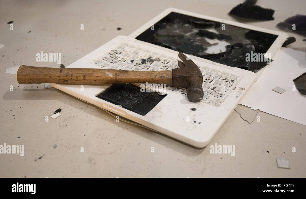 A laptop computer completely destroyed by a hammer. Stock Photo