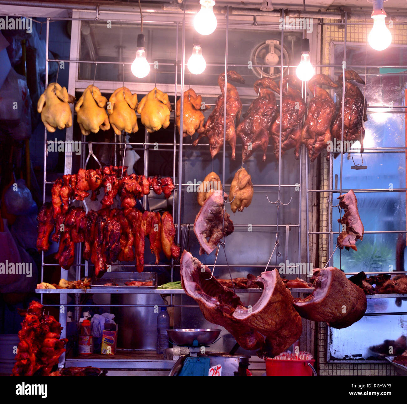 Rack of Cantonese style barbecued meat displayed at shop front, Hong Kong Stock Photo