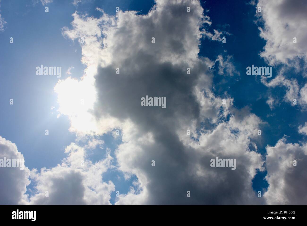 Fluffy White Clouds in a Bright Blue Sky Stock Photo - Alamy