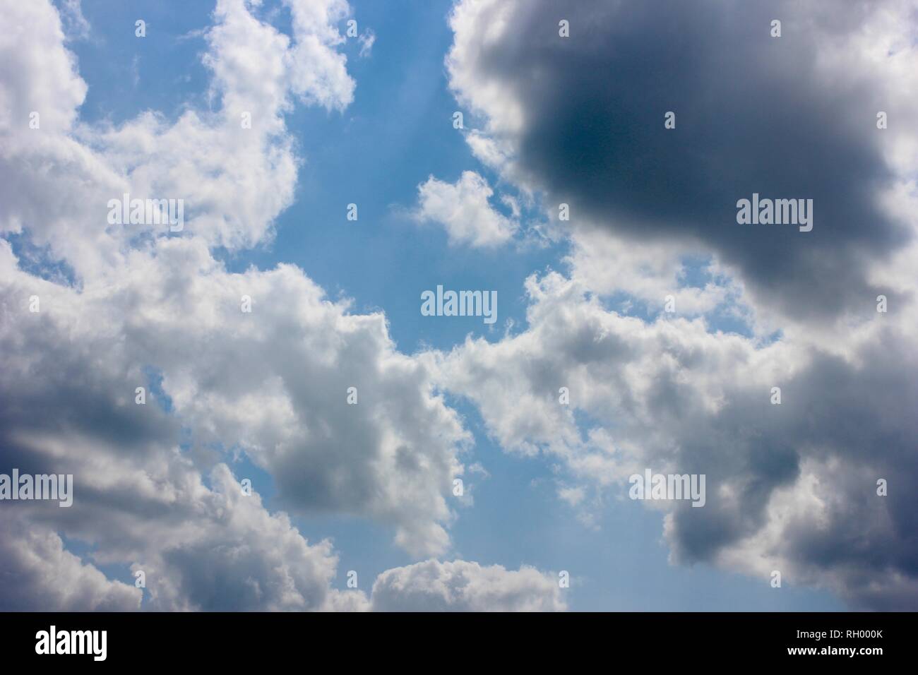 Fluffy White Clouds in a Bright Blue Sky Stock Photo - Alamy