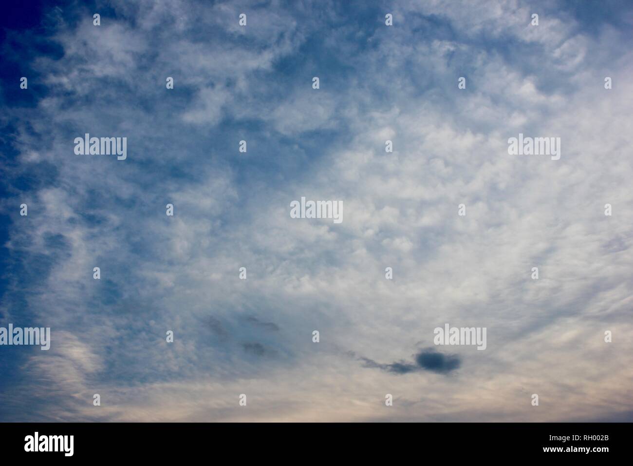 Fluffy White Clouds in a Bright Blue Sky Stock Photo - Alamy