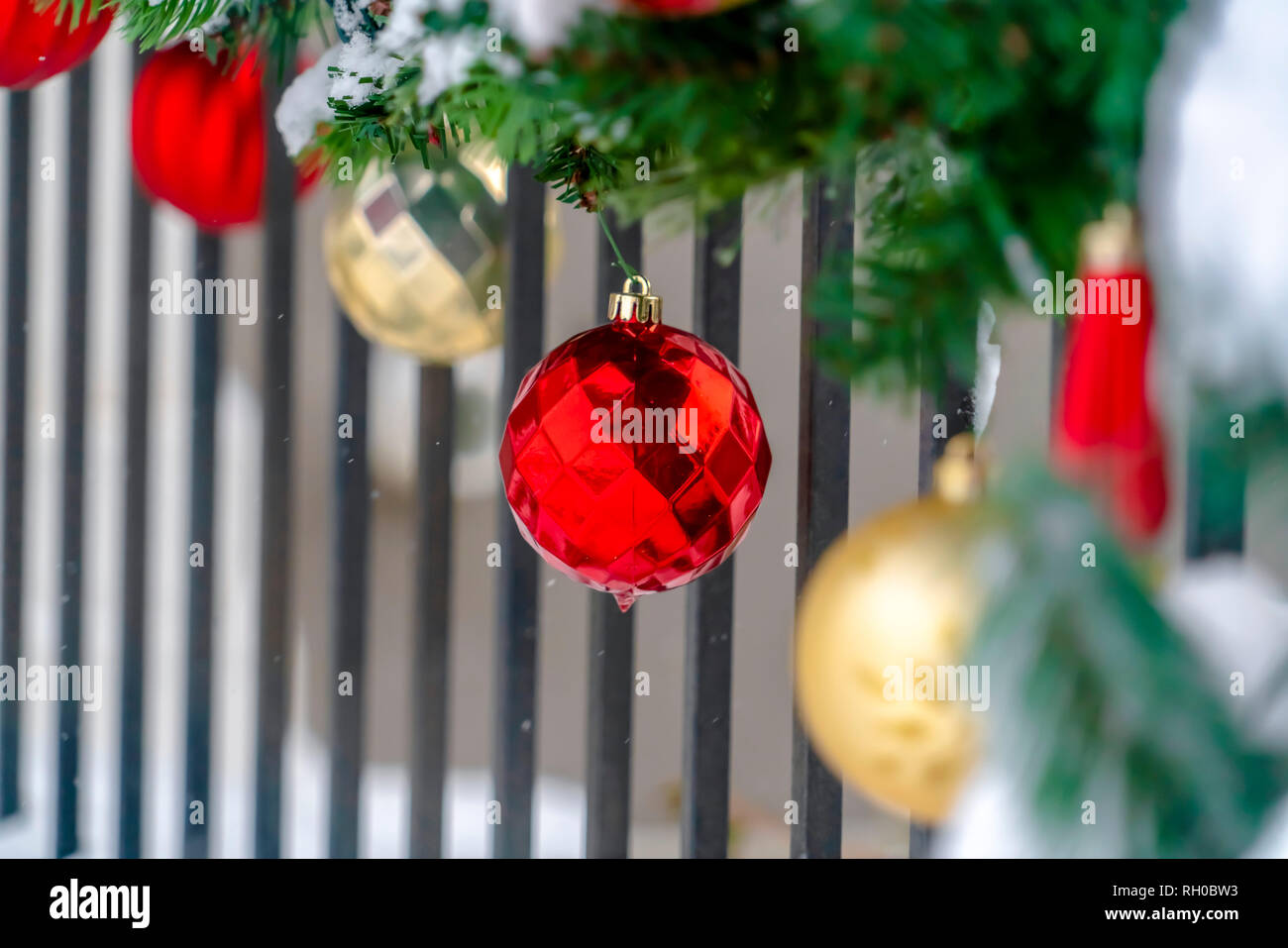 Christmas baubles and garland on a porch railing Stock Photo Alamy