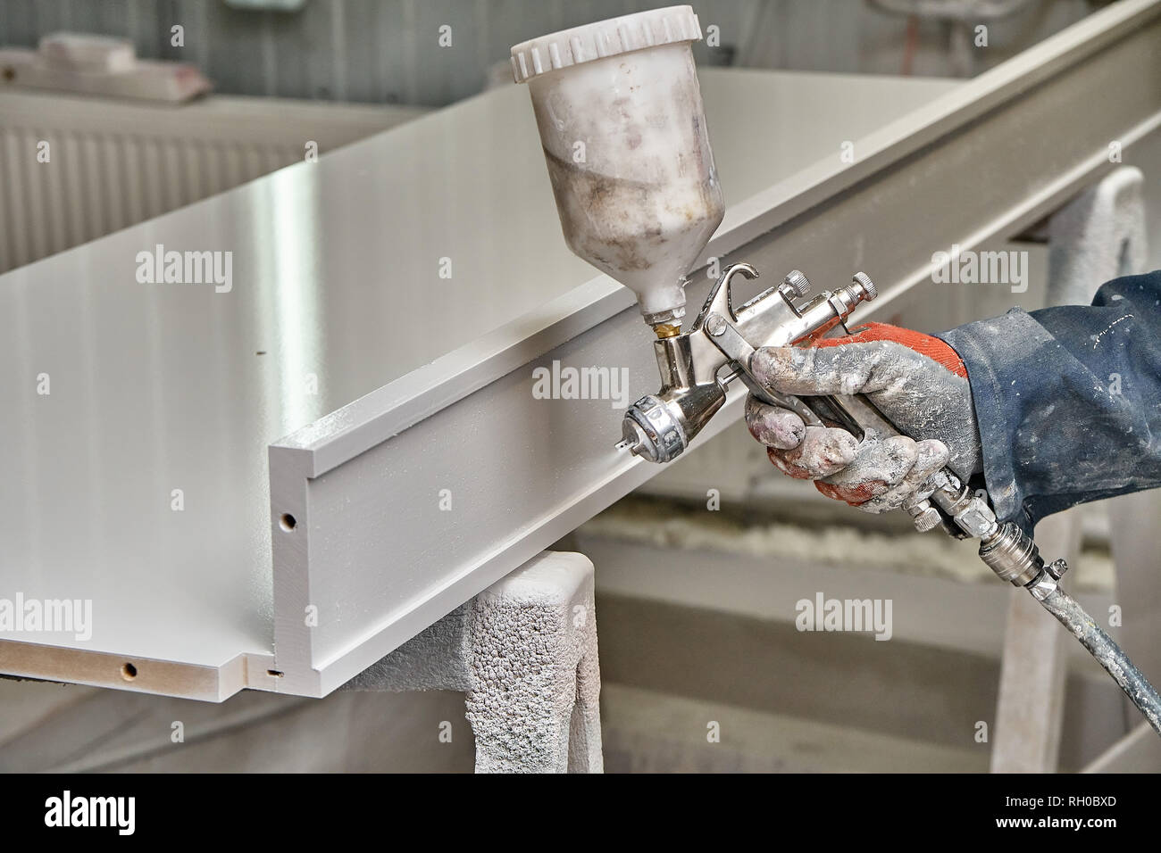 Painting with spray gun. Painting chamber, spray gun. Wooden