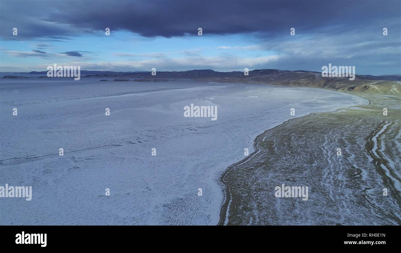 (190130) -- LHASA, Jan. 30, 2019 (Xinhua) -- Photo taken on Jan. 18, 2019 shows the frozen Namtso Lake in southwest China's Tibet Autonomous Region. In the past, herdsmen in Tibet endured a ridiculously long, cold winter from October to the end of June, before moving to the summer meadow. They had no fixed residence and migrated when the seasons changed, taking their tents, kitchen utensils and other necessities on horseback. Nowadays, most herdsmen benefit from local resettlement program. They said goodbye to their winter hovels and moved into brick-and-mortar Tibetan-style homes. (Xinhu Stock Photo