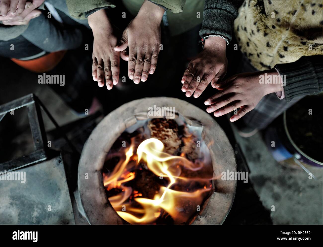 (190130) -- LHASA, Jan. 30, 2019 (Xinhua) -- Herdswoman Qimei and her family warm themselves at a herdsman resettlement site in Bange County, southwest China's Tibet Autonomous Region, Jan. 17, 2019. In the past, herdsmen in Tibet endured a ridiculously long, cold winter from October to the end of June, before moving to the summer meadow. They had no fixed residence and migrated when the seasons changed, taking their tents, kitchen utensils and other necessities on horseback. Nowadays, most herdsmen benefit from local resettlement program. They said goodbye to their winter hovels and move Stock Photo