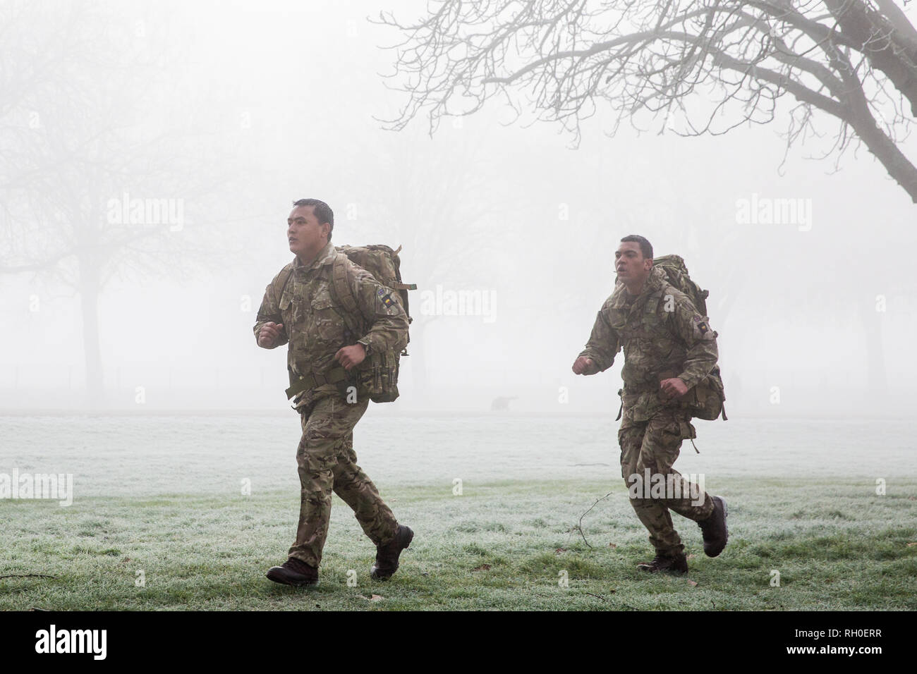 Windsor, UK. 31st January, 2019. UK Weather: Soldiers train with backpacks in frosty and foggy conditions alongside the Long Walk in Windsor Great Park. There are two barracks in Windsor, the Victoria Barracks which currently houses the 1st Battalion Coldstream Guards and the Combermere Barracks which houses the Household Cavalry Regiment. Freezing fog patches are expected to clear slowly in south-east England during the morning, to be followed by cloud, sleet and snow in the east. Credit: Mark Kerrison/Alamy Live News Stock Photo