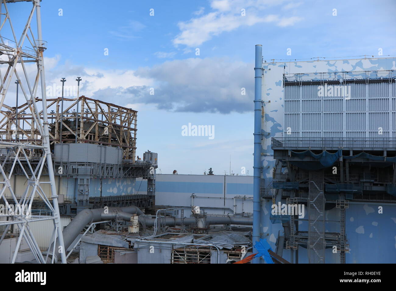 31 January 2019, Japan, Fukushima: View of the severely damaged reactor 1 (l) of the atomic ruin Fukushima Daiichi and on the right reactor 2. On 11 March 2011 the power plant had reached Super Gau due to an earthquake and tsunami. Due to the radioactive radiation from core meltdowns in three reactors, around 160,000 residents had to flee. More than 30,000 are still unable to return to their homes. It was the worst nuclear disaster since Chernobyl in 1986, but in the meantime, according to Tepco, the conditions of the thousands of workers have improved considerably and they no longer need to w Stock Photo