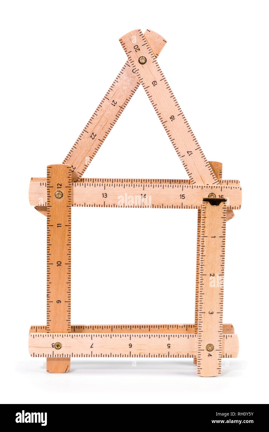 Wooden folding inch ruler in the shape of two house. Isolated on white background. Clipping path included. Stock Photo
