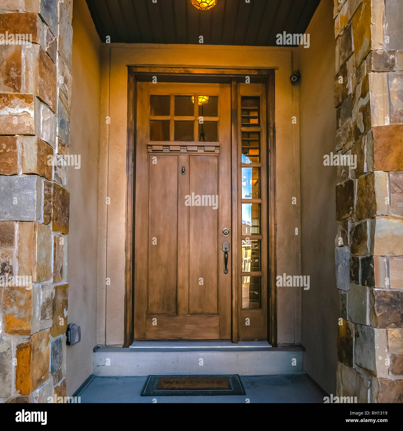 Entryway of home with glass panes on front door Stock Photo Alamy