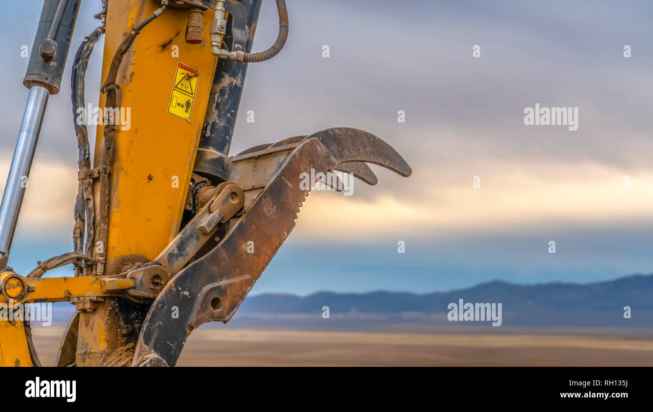 Excavator arm against mountain and sky in Utah Stock Photo - Alamy