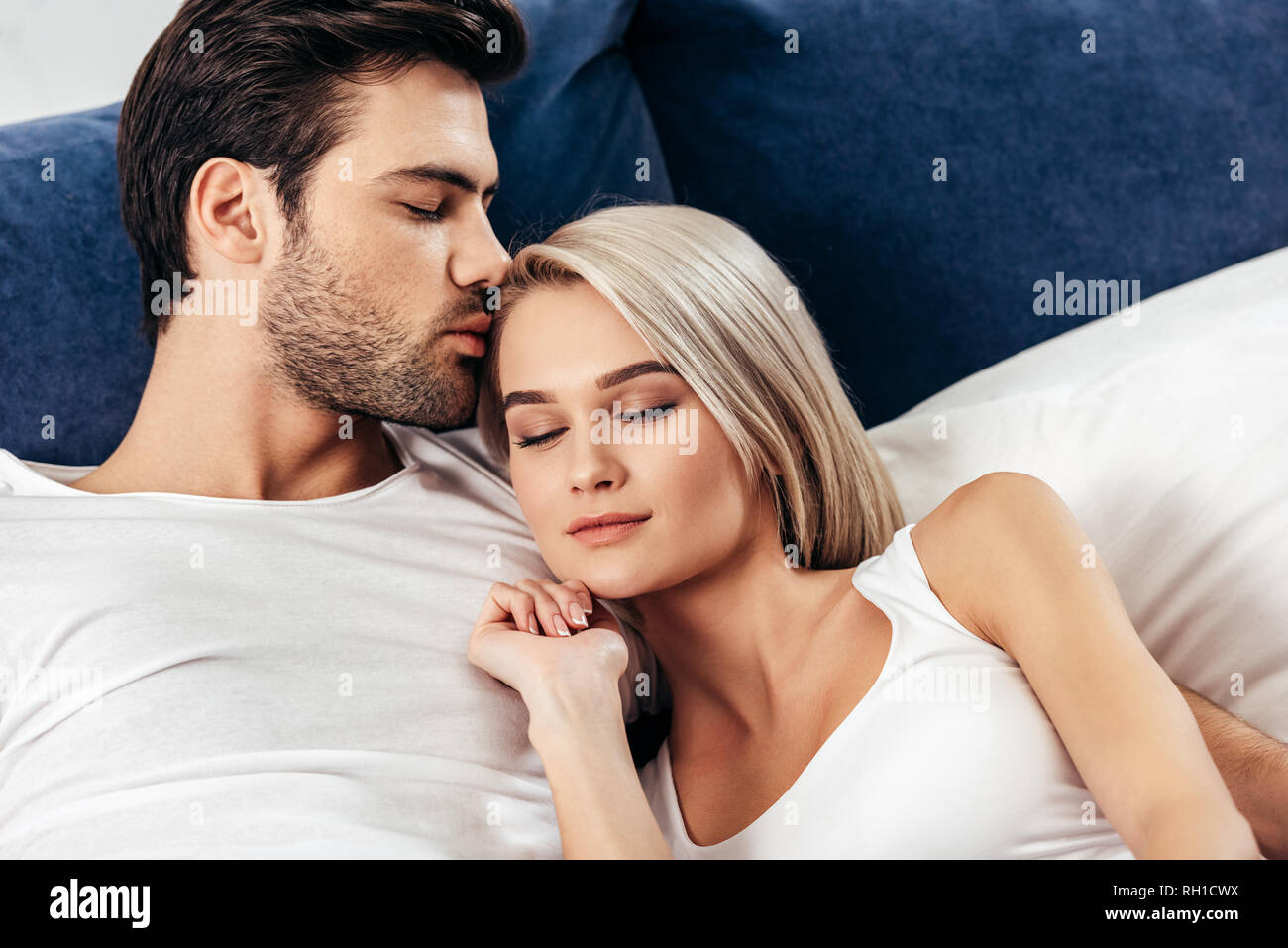 selective focus of attractive girlfriend and handsome boyfriend kissing