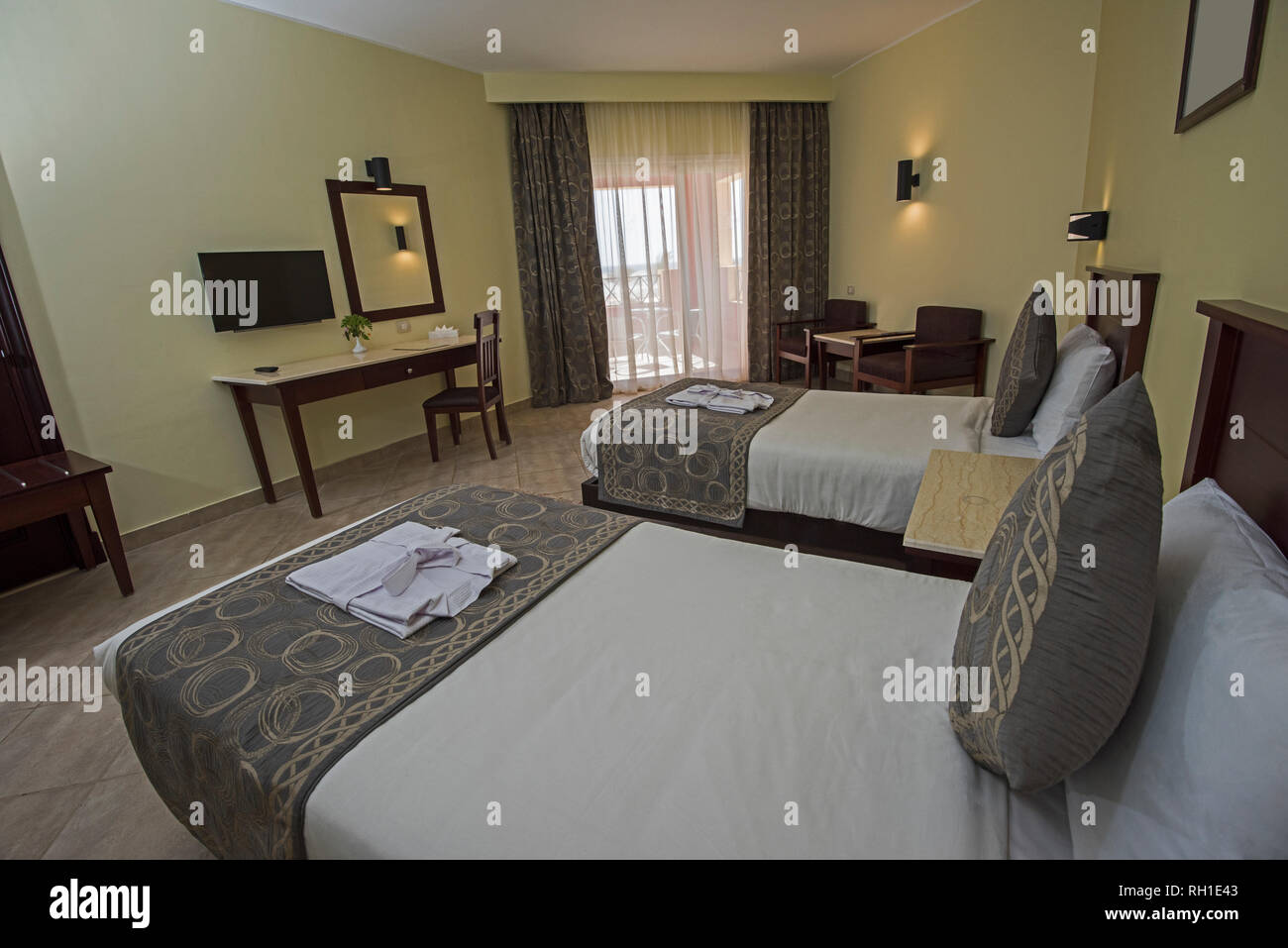 Twin Beds In A Luxury Hotel Resort Room With Curtains And Balcony