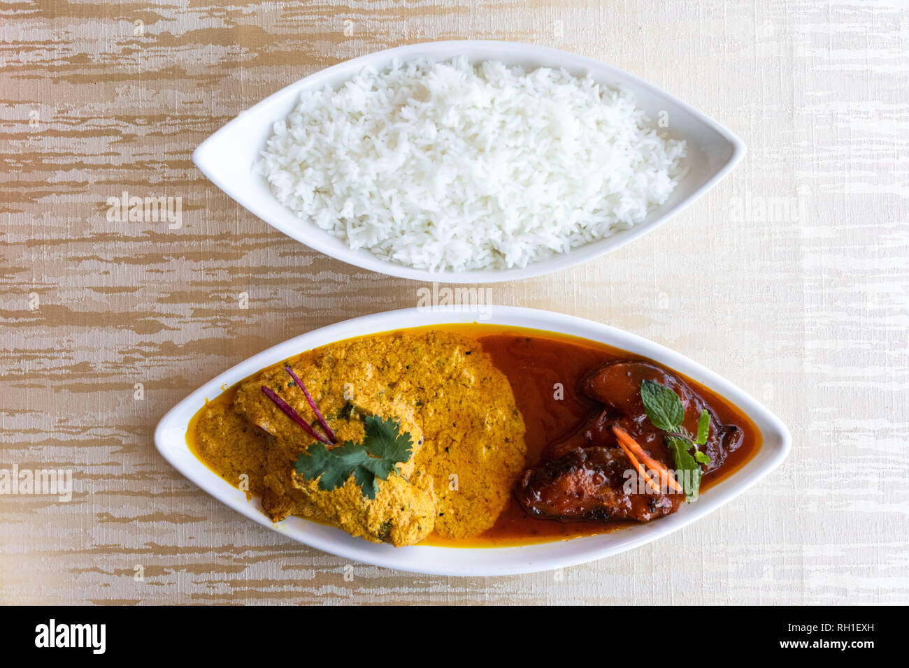 Katla Macher Jhal is a famous bengali fish curry served in two contrasting gravies-one sweetly pungent and the other spicy and tangy Stock Photo