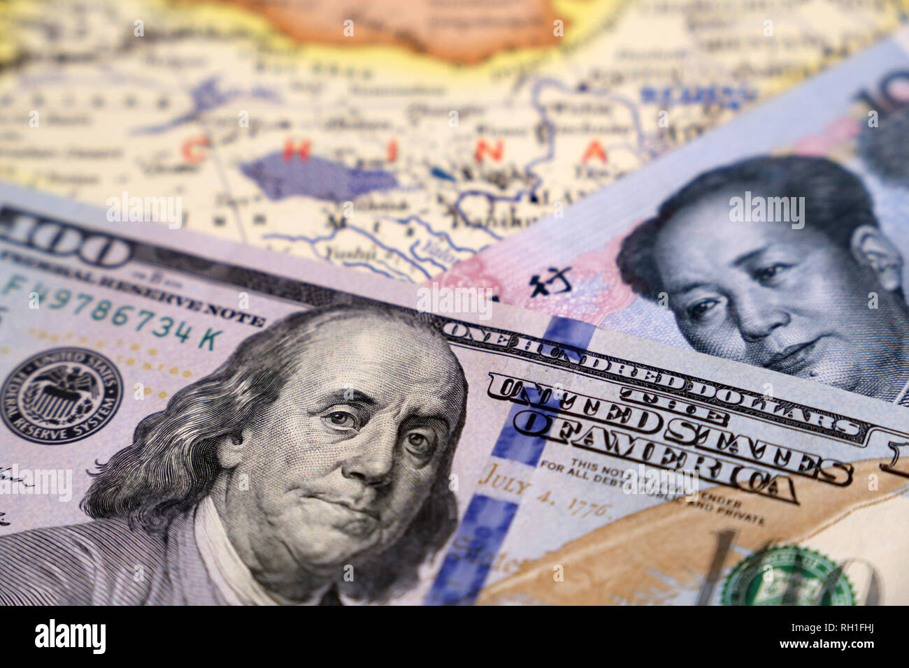 US dollars and chinese yuan on the map of China. Trade war between US and China, economic sanctions Stock Photo