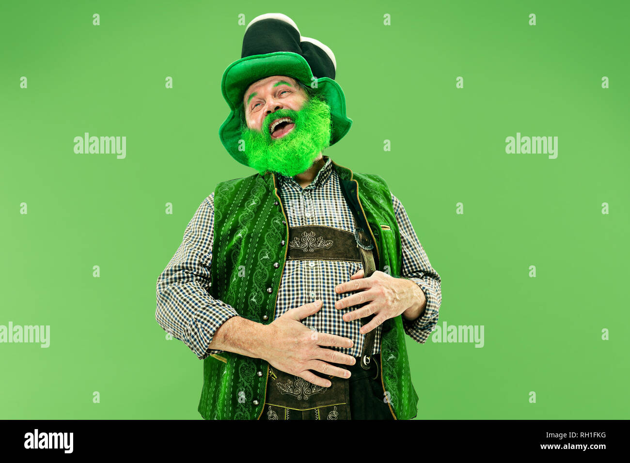happy senior man in a leprechaun hat 