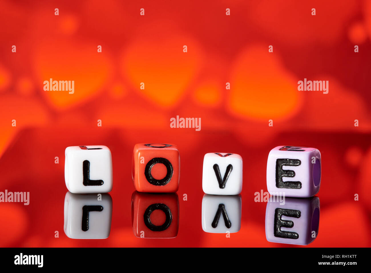 Word love  from cubes with reflection on bright blurred background. Stock Photo