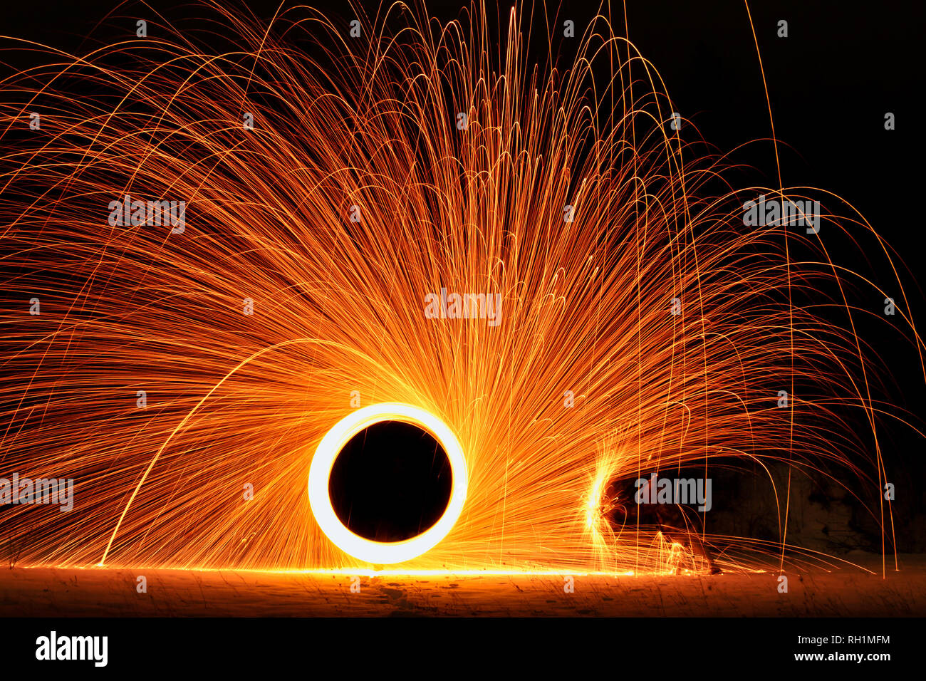 Steel wool photography with umbrella like a protection from burning steel Stock Photo