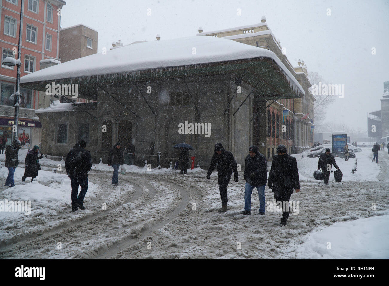 Istanbul, Eminonu, Turkey - January 9, 2017: Istanbul was covered with snow.There were people at the streets of The Eminonu with a fountain. Stock Photo