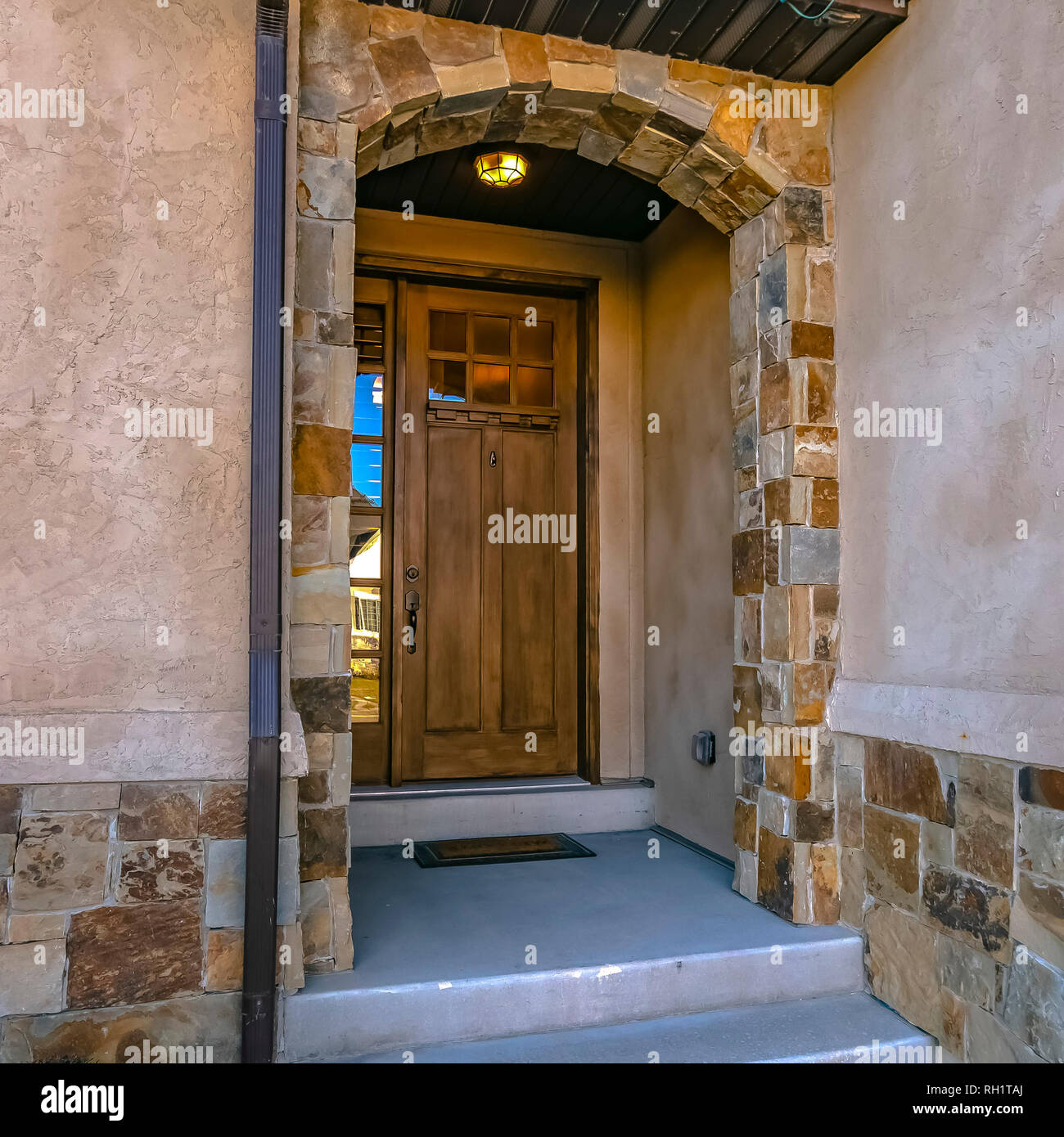 Home with arched entryway and brown door in Utah Stock Photo Alamy
