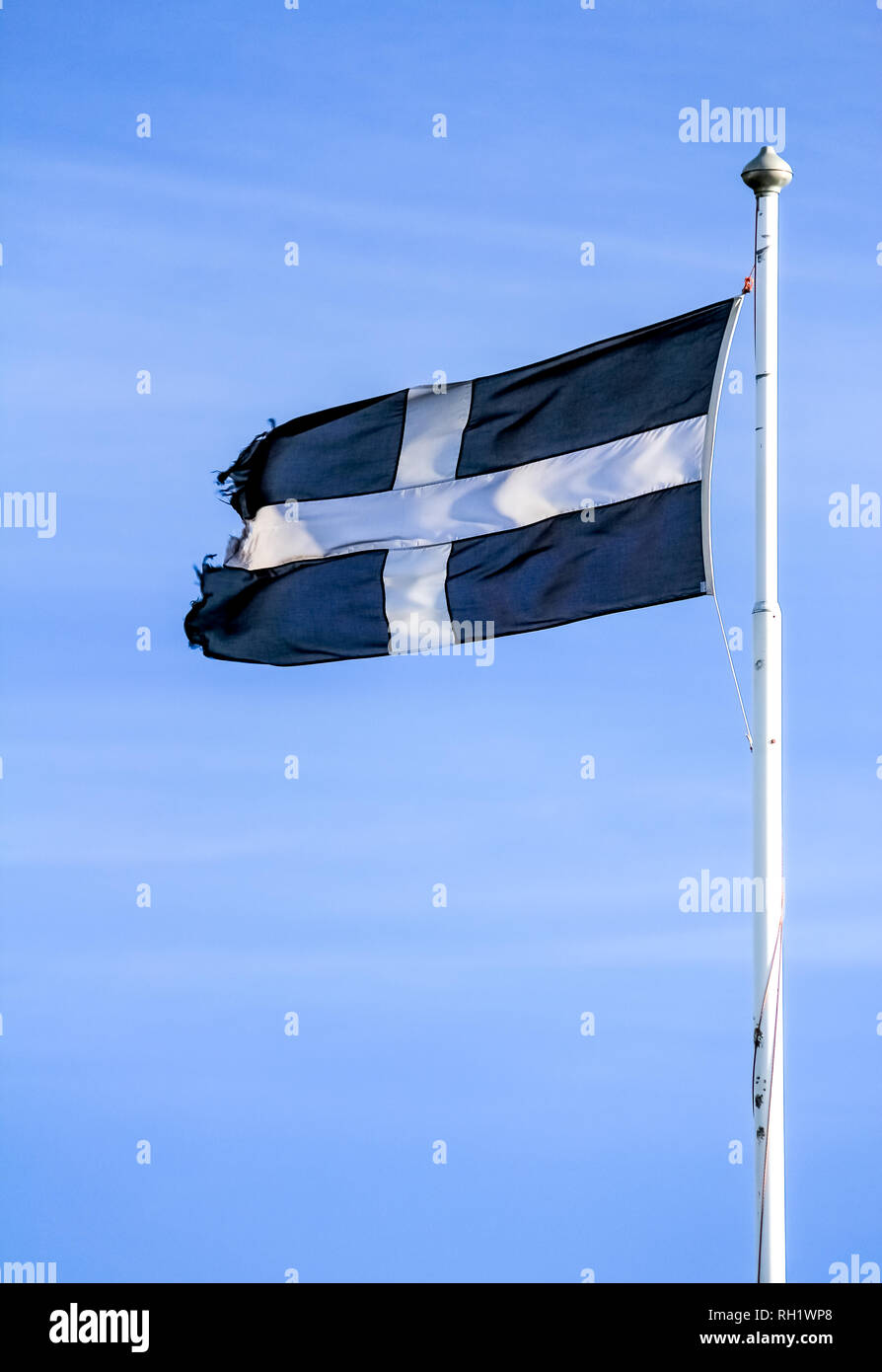 Saint Pirans Flag, the flag of Cornwall, UK. White cross on a black background. Stock Photo