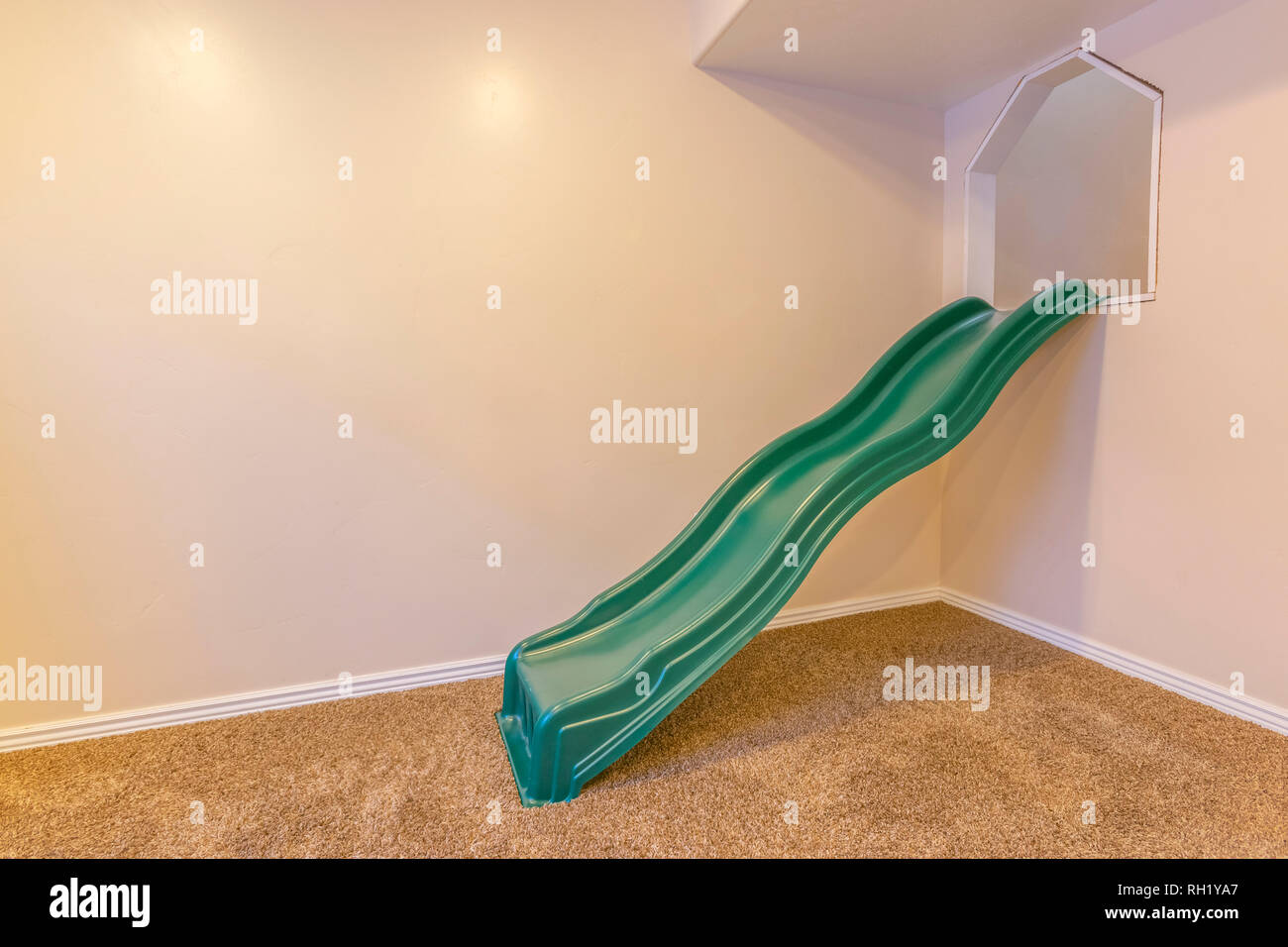 Indoor playground with slide against a white wall Stock Photo Alamy